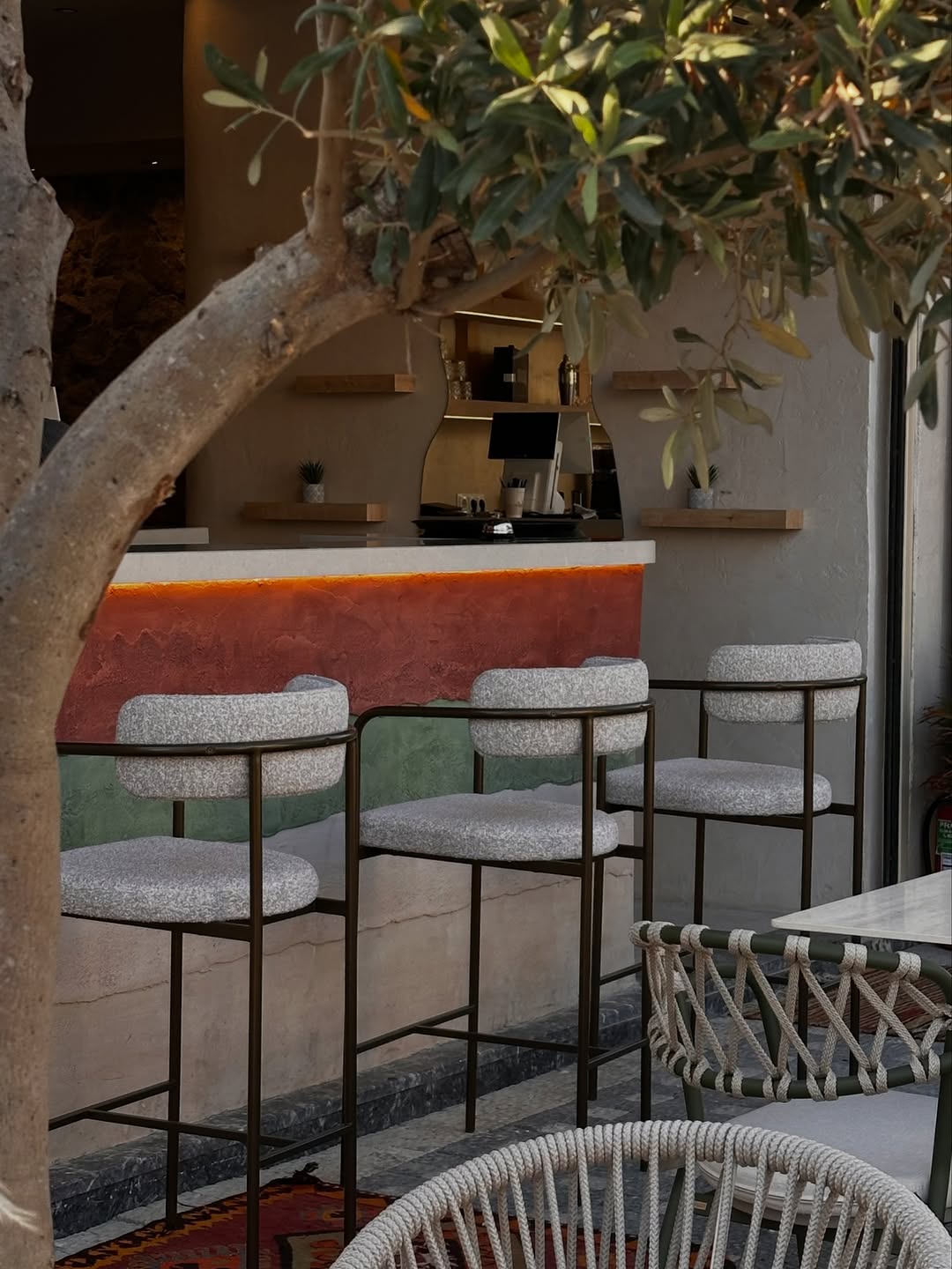 Terracotta bar with boucle stools